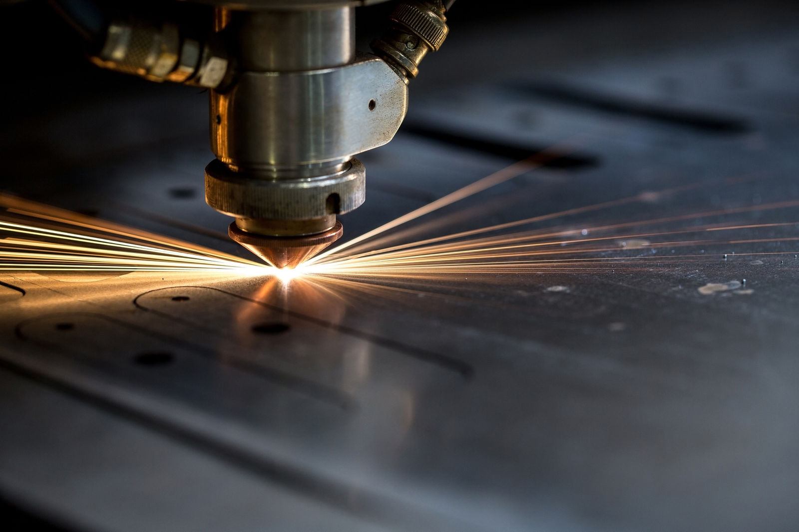 Laser cutting head cutting steel with sparks