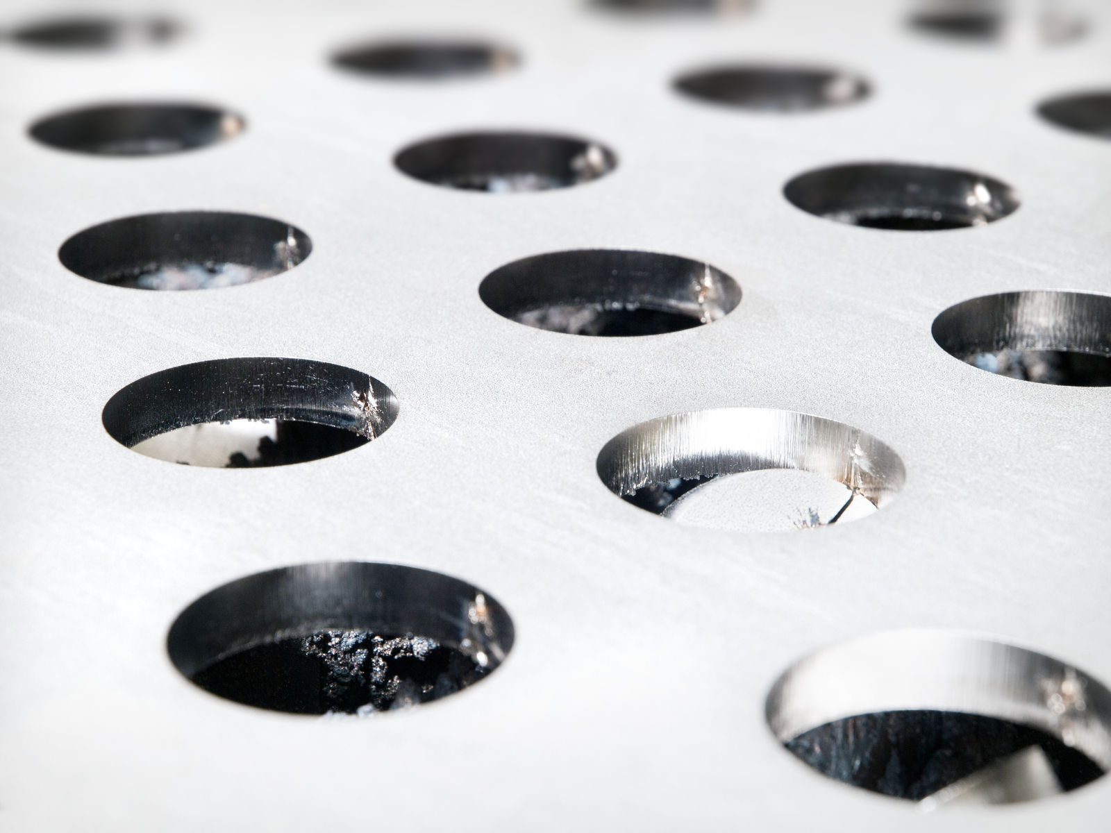 Countersunk holes in a metal sheet