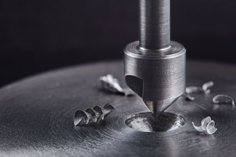 Countersink bit cutting a bevel in a hole